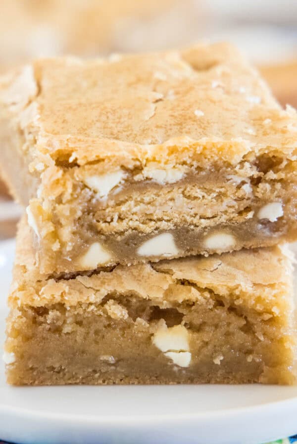 close up golden oreo blondies stacked on a white plate
