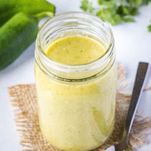 close up green enchilada sauce in a jar
