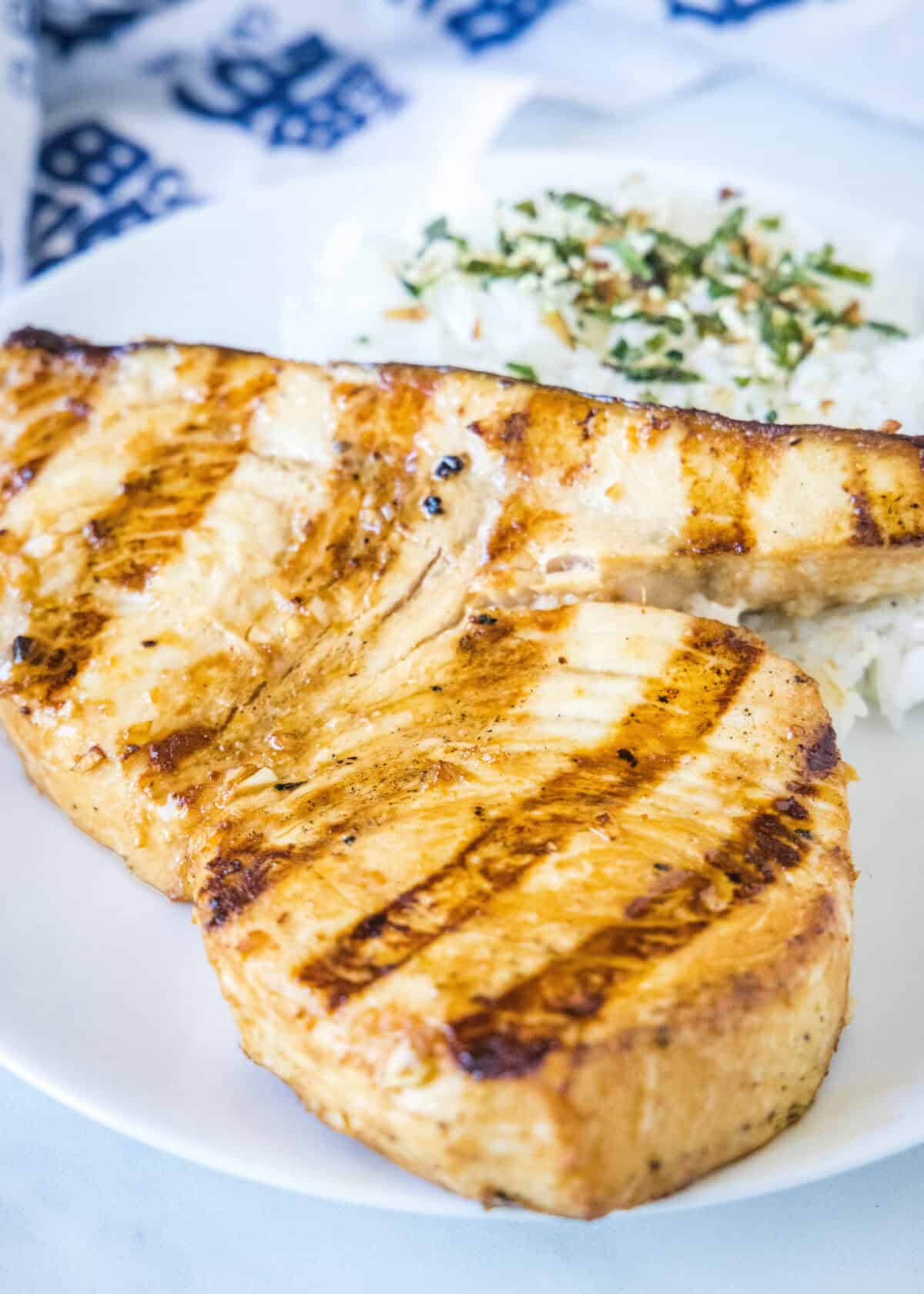 grilled swordfish on a plate with rice
