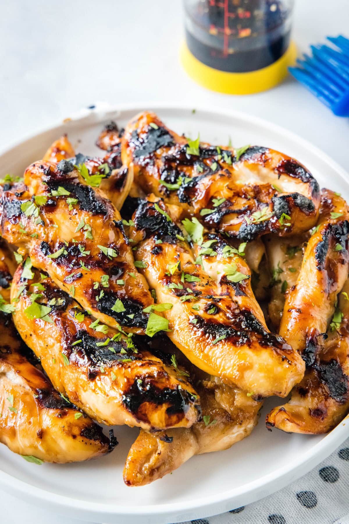 Teriyaki grilled chicken piled on a white platter.