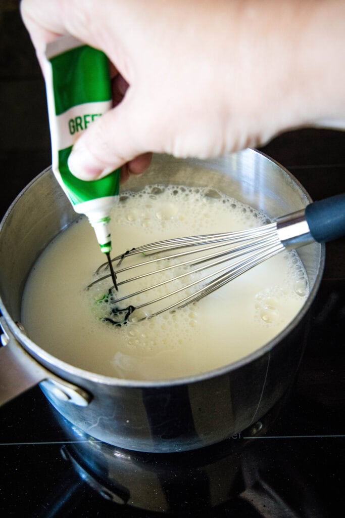 adding food coloring to white hot chocolate