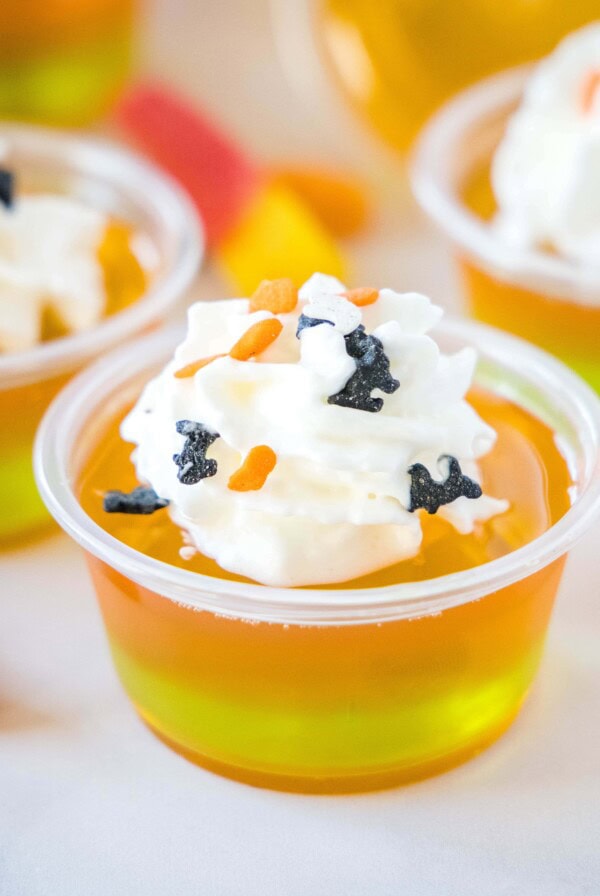 cropped closeup of orange and green layered jello shots