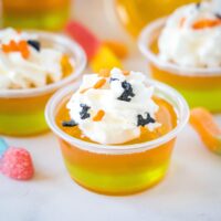 cropped closeup of orange and green layered jello shots