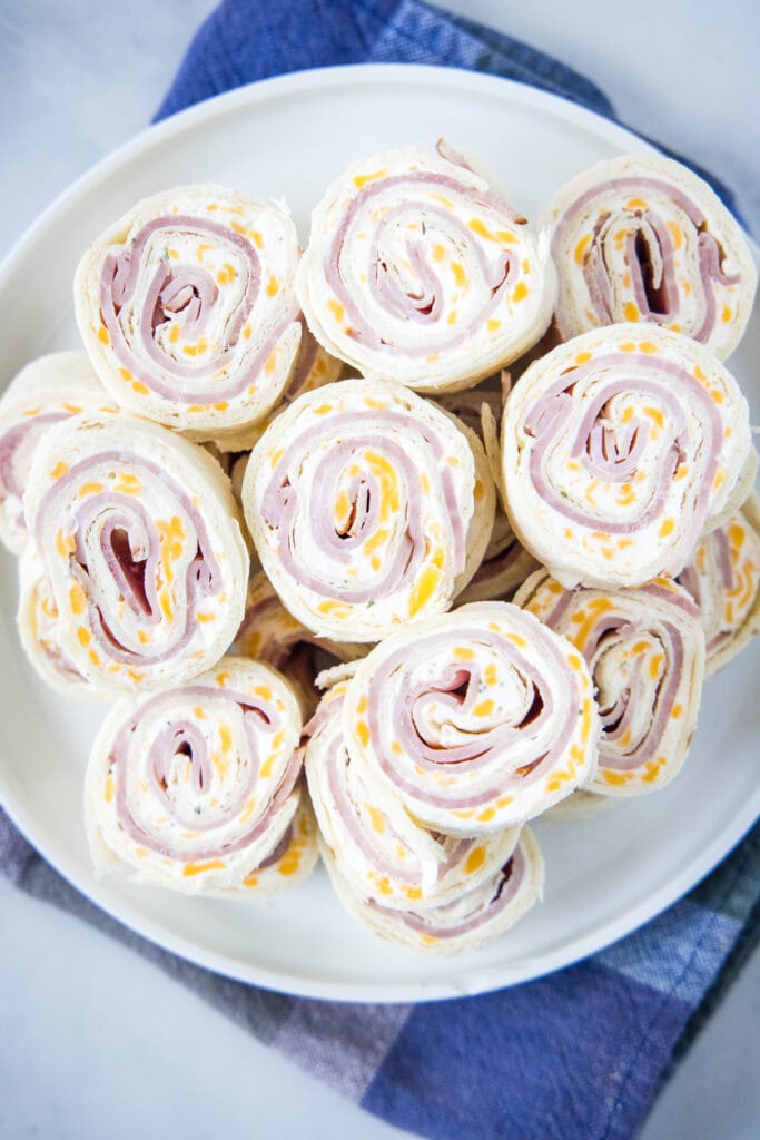 looking down on a plate of ham and cheese pinwheels