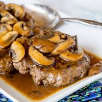 Hamburger Steaks with Mushroom Gravy -easy comfort food that won't break the bank! Rich mushroom gravy over tender hamburger steaks is a great weeknight dinner.