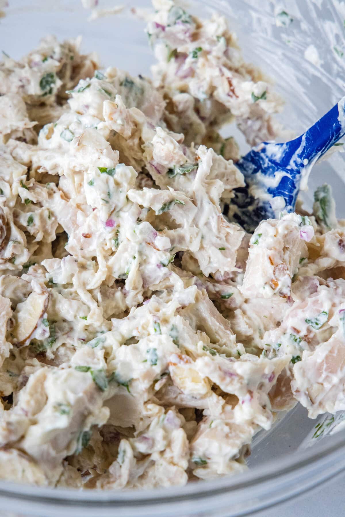 greek yogurt chicken salad mixed together in a mixing bowl