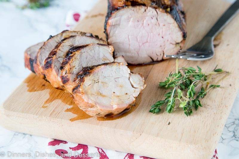 A piece of pork sitting on top of a wooden cutting board, with Pork and Pork tenderloin
