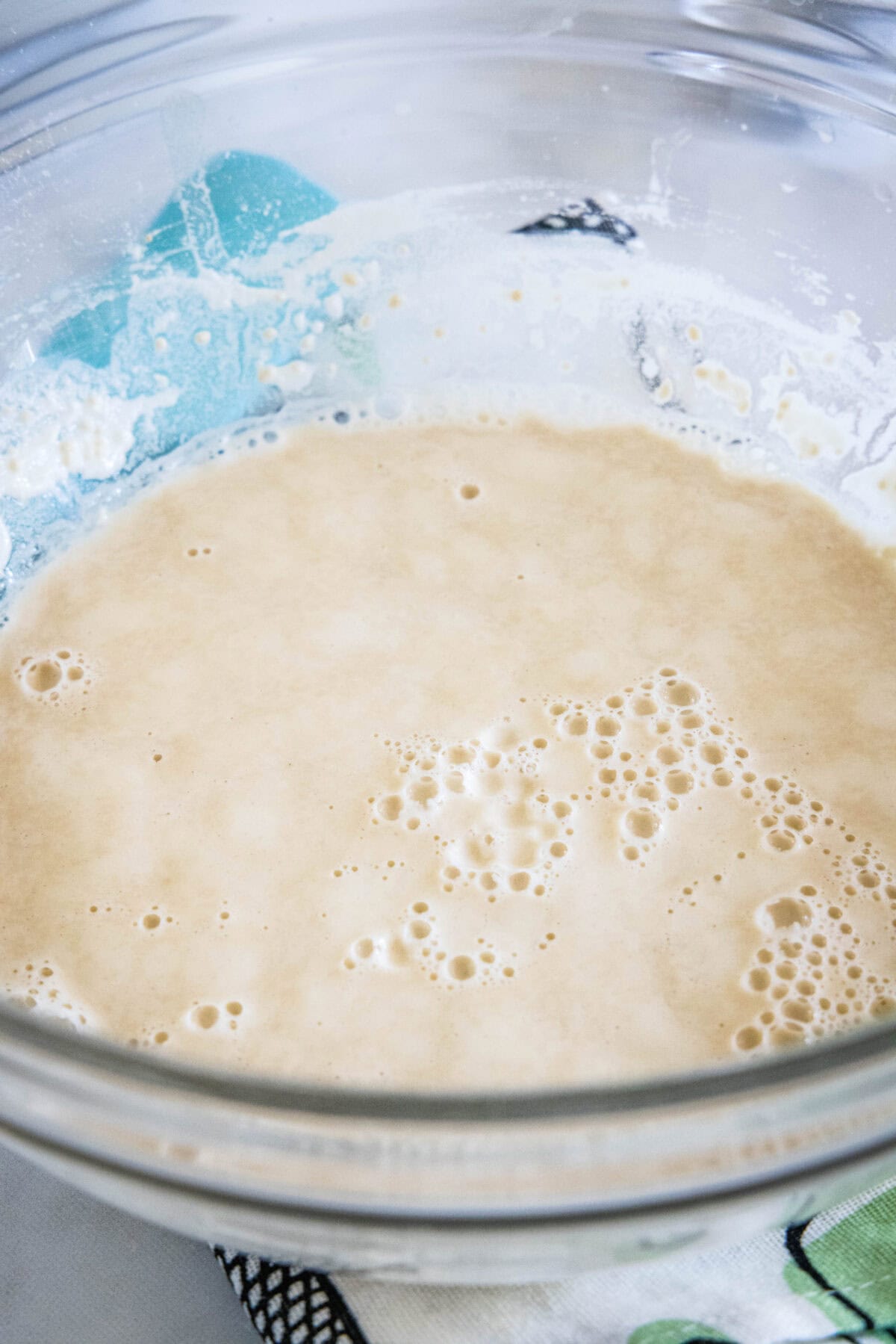 Wet dough mixture in a glass bowl.
