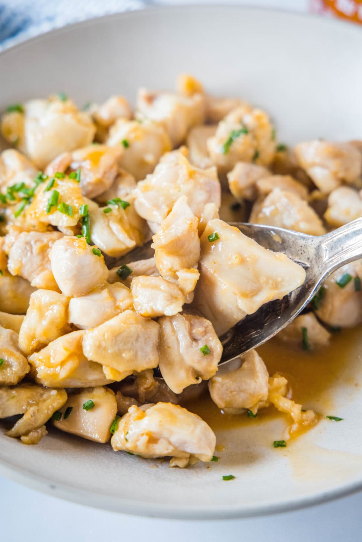 spooning chicken bites out of a bowl