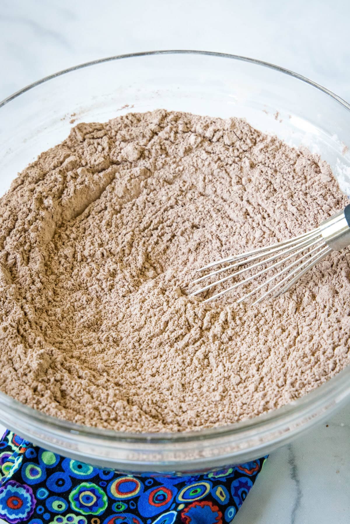 Homemade hot chocolate mix whisked together in a glass bowl.