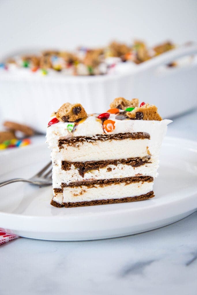 Ice cream sandwich cake with fresh whipped cream and topped like an ice cream sundae