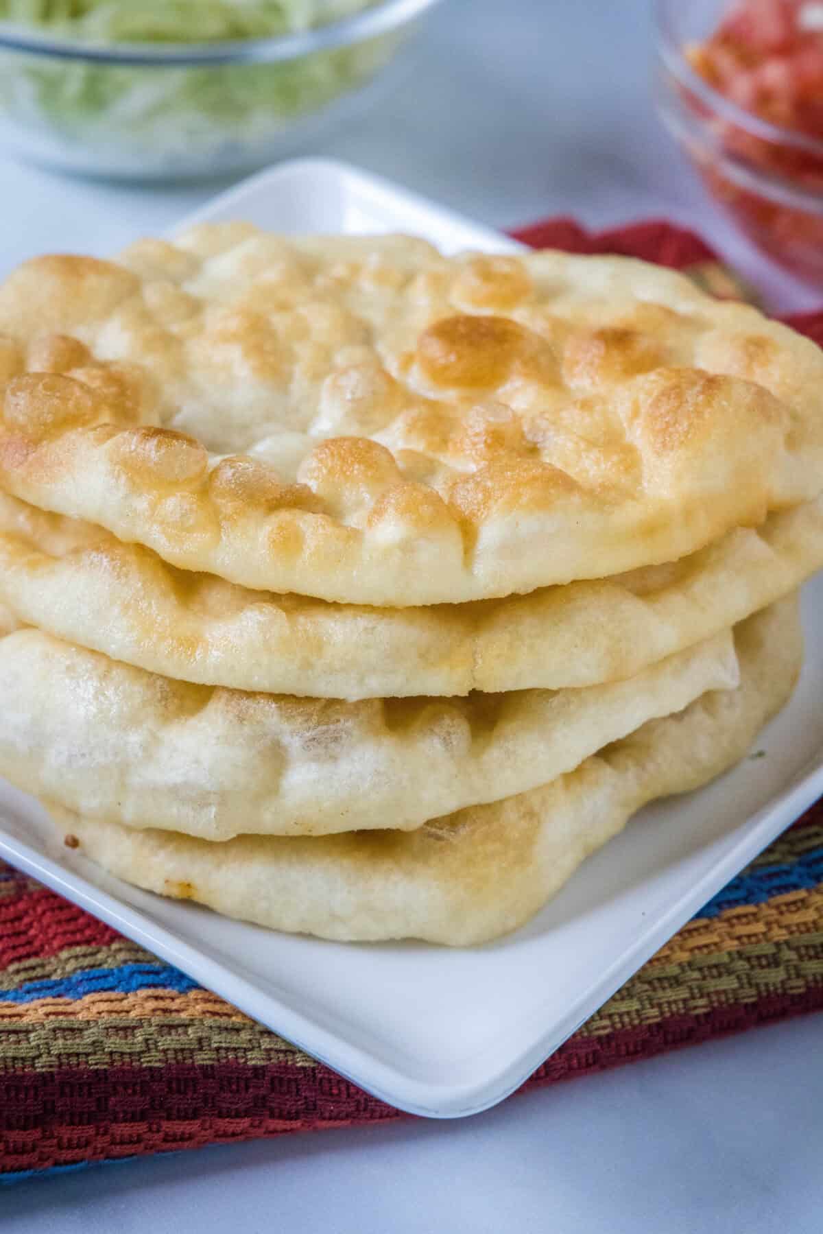 stacked indian fry bread on a plate