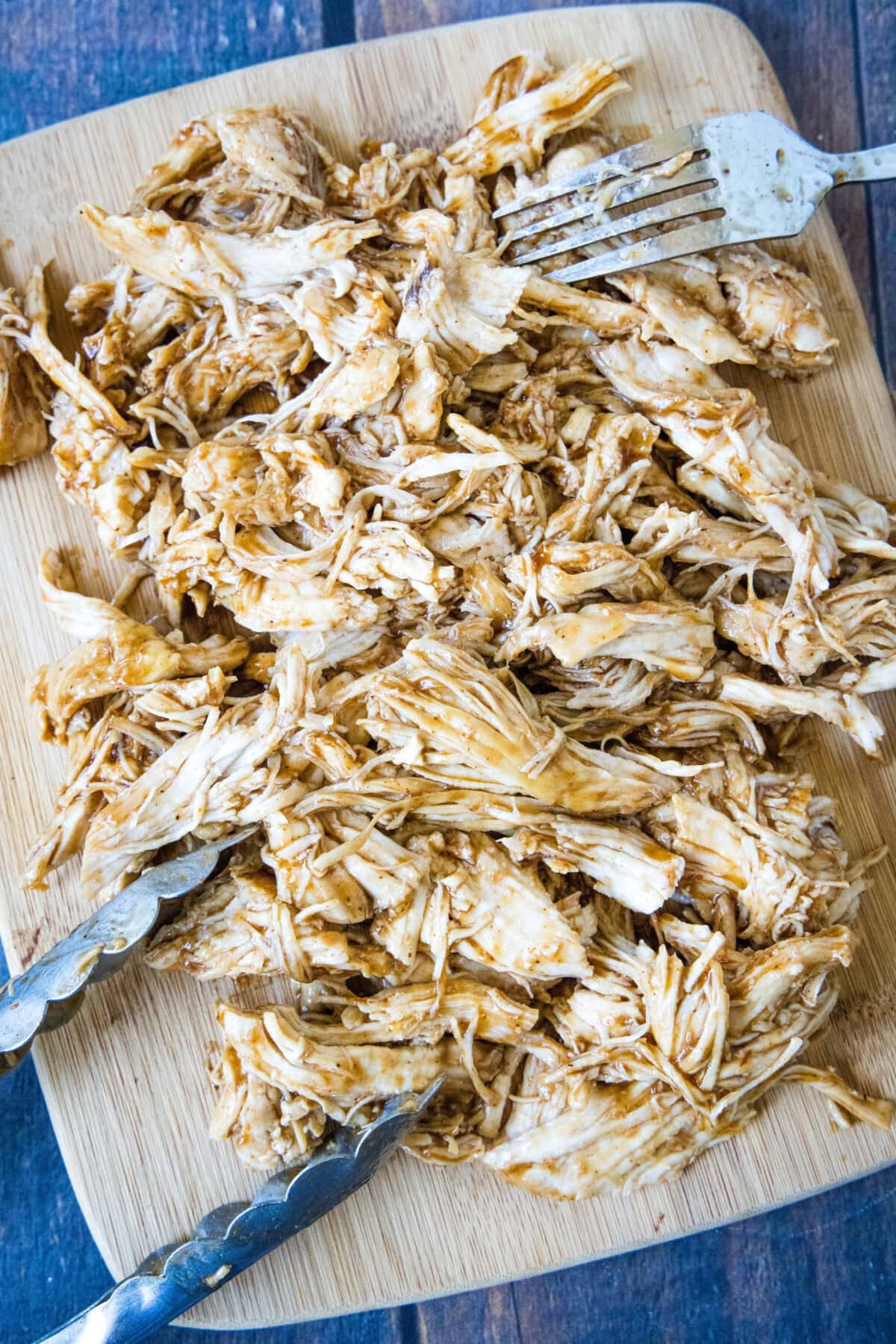 shredded bbq chicken on a cutting board