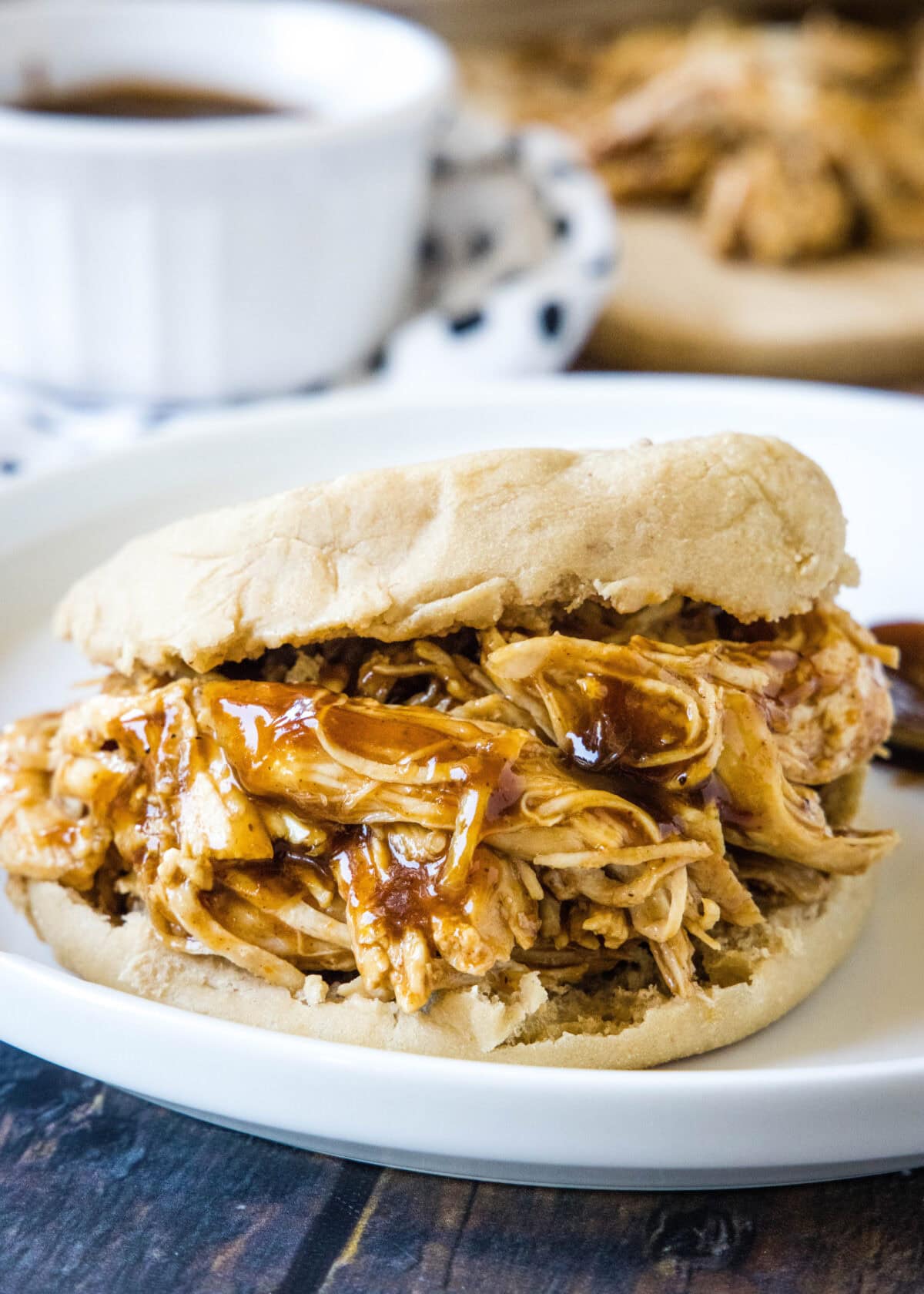 shredded bbq chicken on an english muffin on a plate