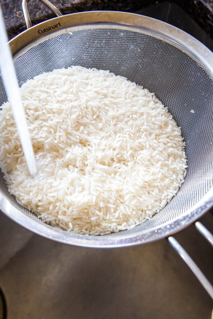 rinsing white rice in the sink