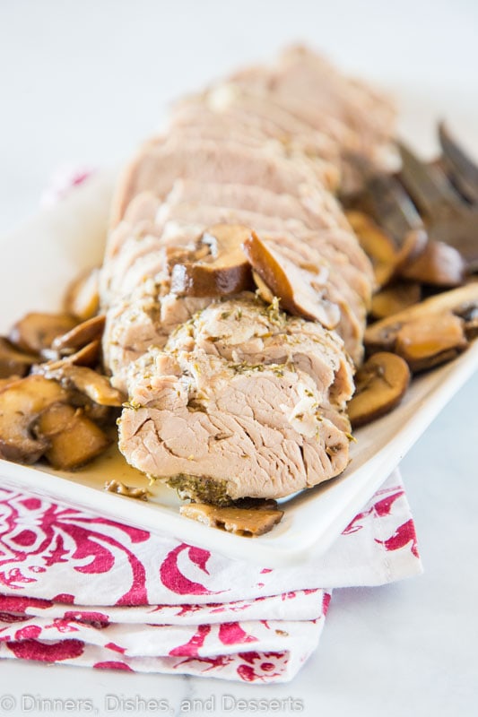 Sliced pork tenderloin with mushrooms on a plate, with Pork and Dinner