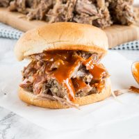 A close up of a sandwich on a plate, with Pork