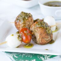 Italian Meatball Caprese Skewers - Make summer entertaining easy with these little skewers. An Italian style meatball, fresh Mozzarella cheese, and tomato, topped with a basil vinaigrette!