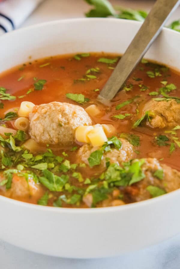 close up italian meatball soup in a bowl