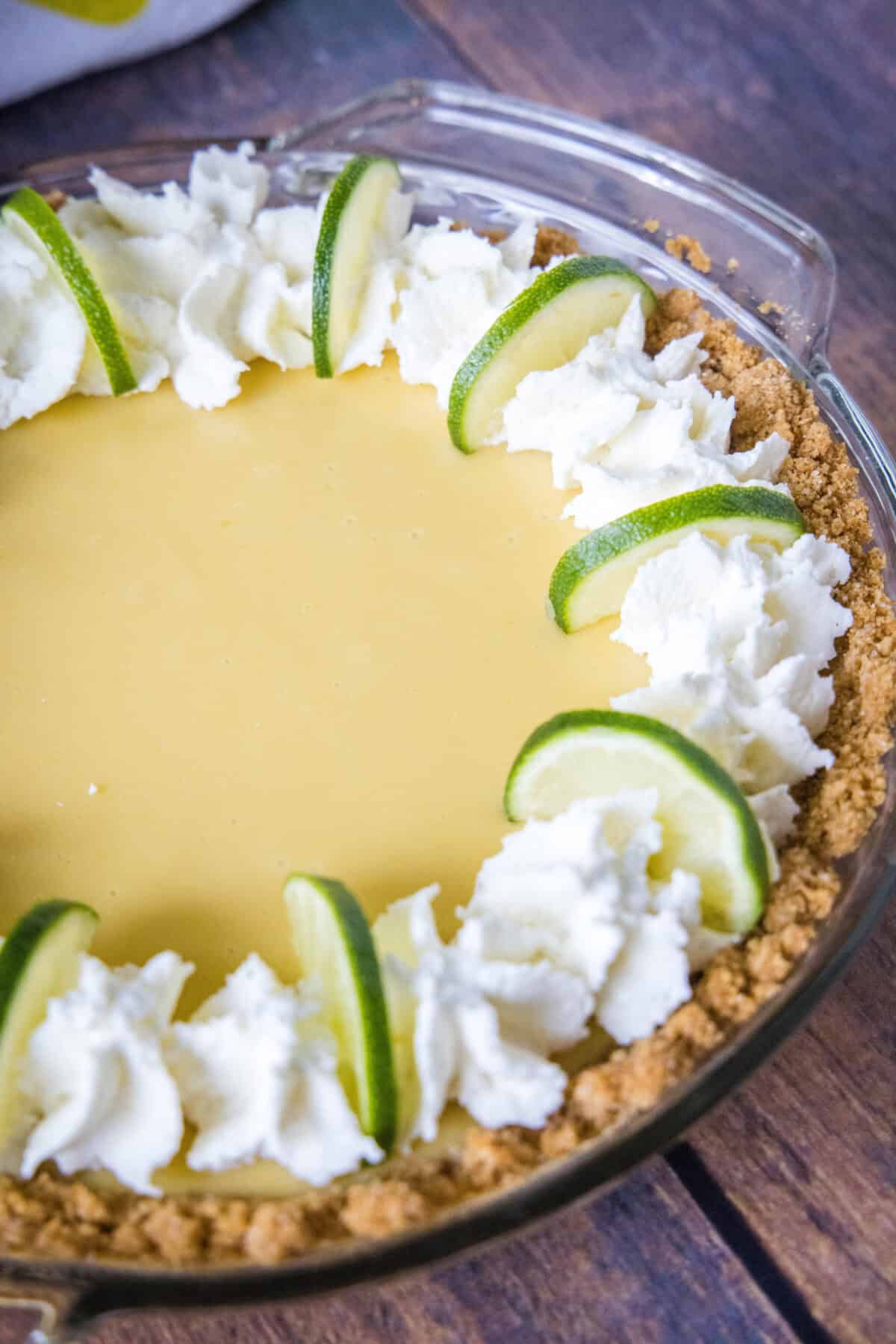 key lime pie with whipped cream and lime slices
