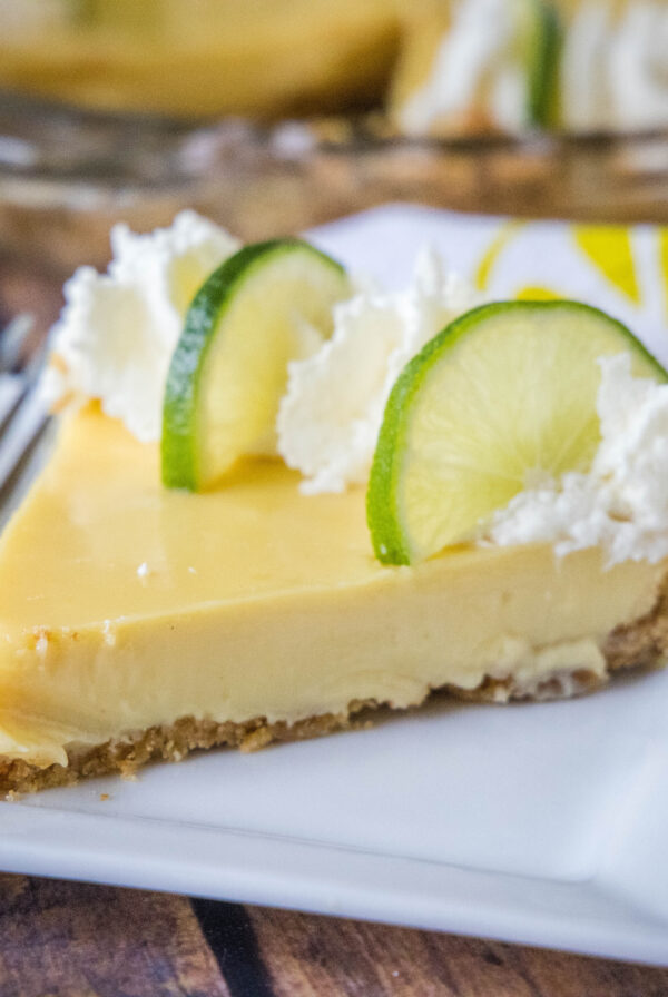 close up key lime pie slice on a white plate