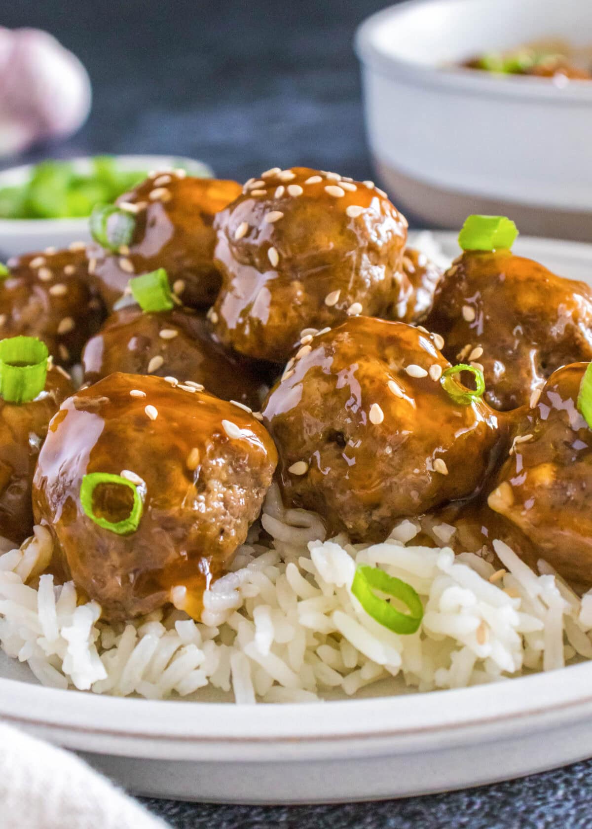 korean meatballs over white rice on a plate