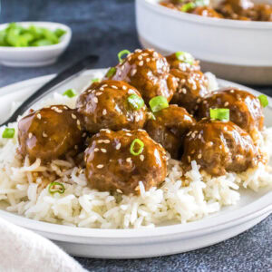 close up korean meatballs over rice on a plate