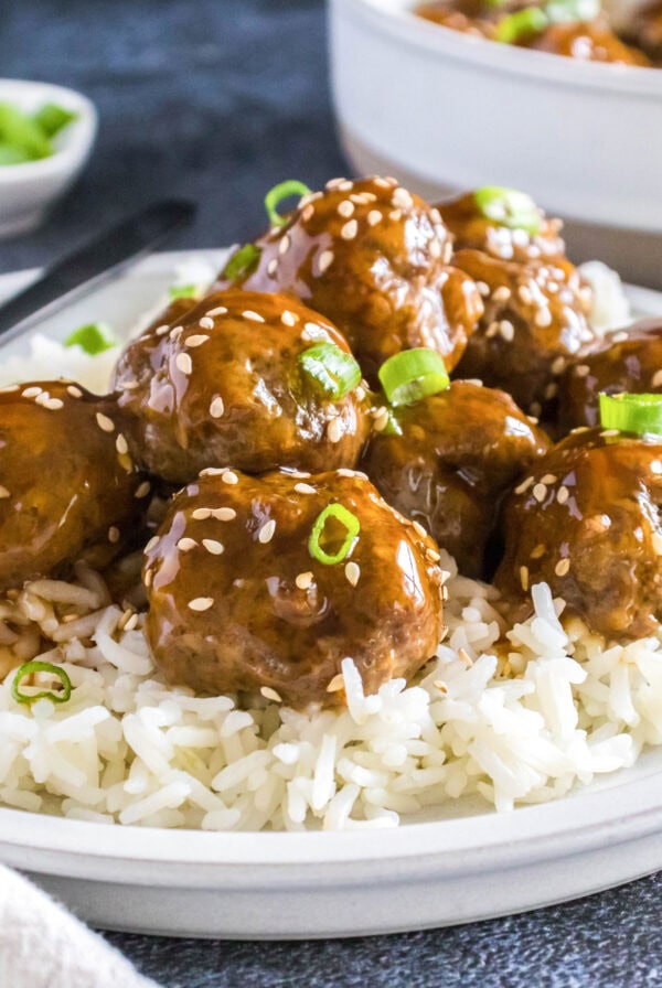 close up korean meatballs over rice on a plate