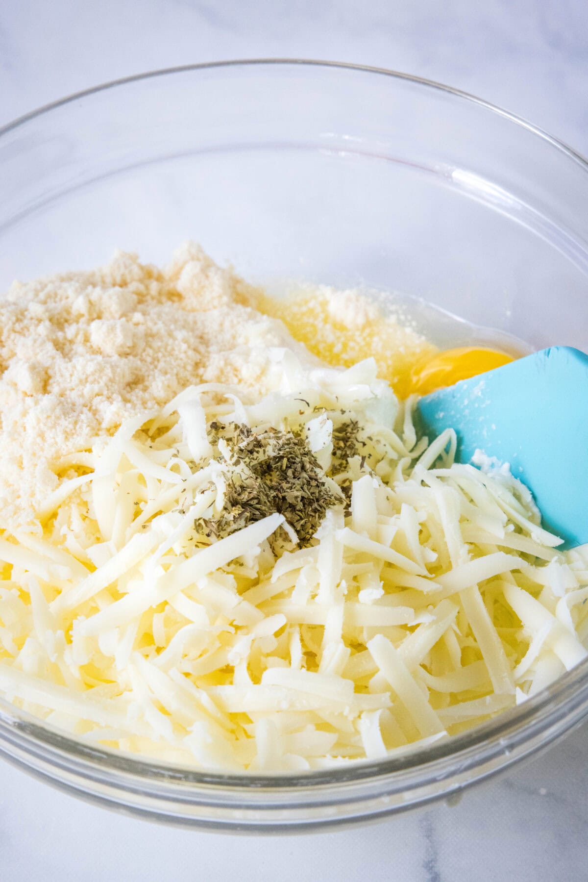 Cheese mixture combined in a glass bowl.