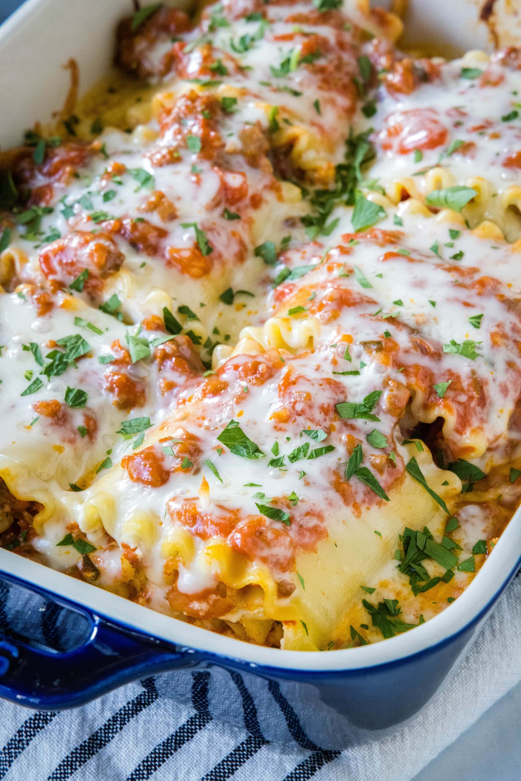 Lasagna roll ups in a baking dish.