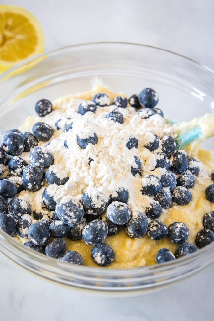 mixiing blueberries into muffin batter