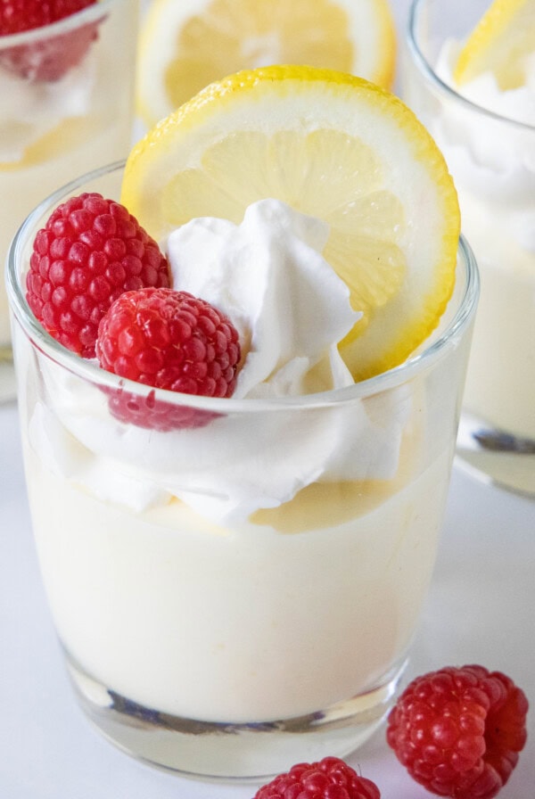 cropped close up lemon mousse topped with whipped cream