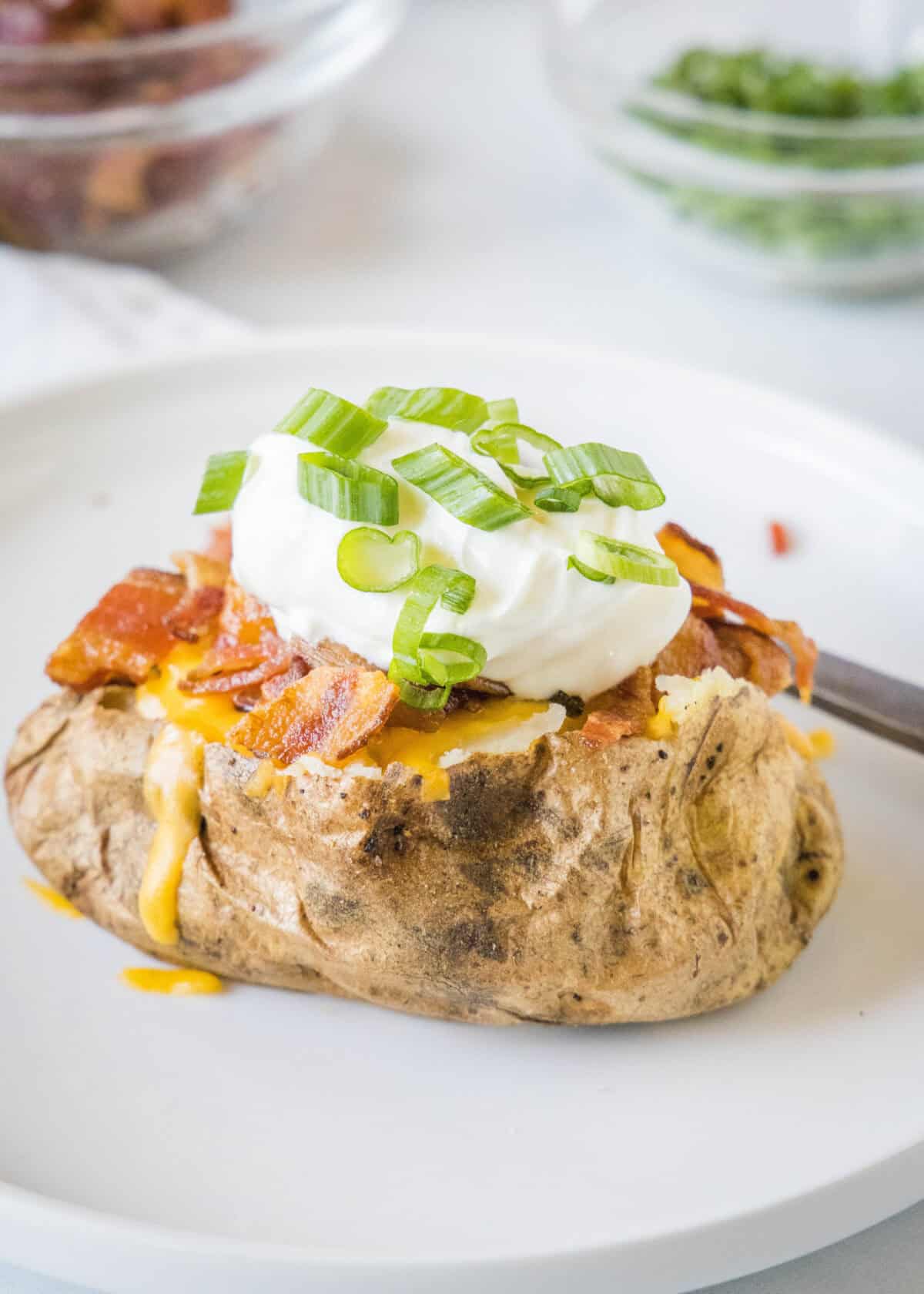 looking down on plate with a loaded baked potato