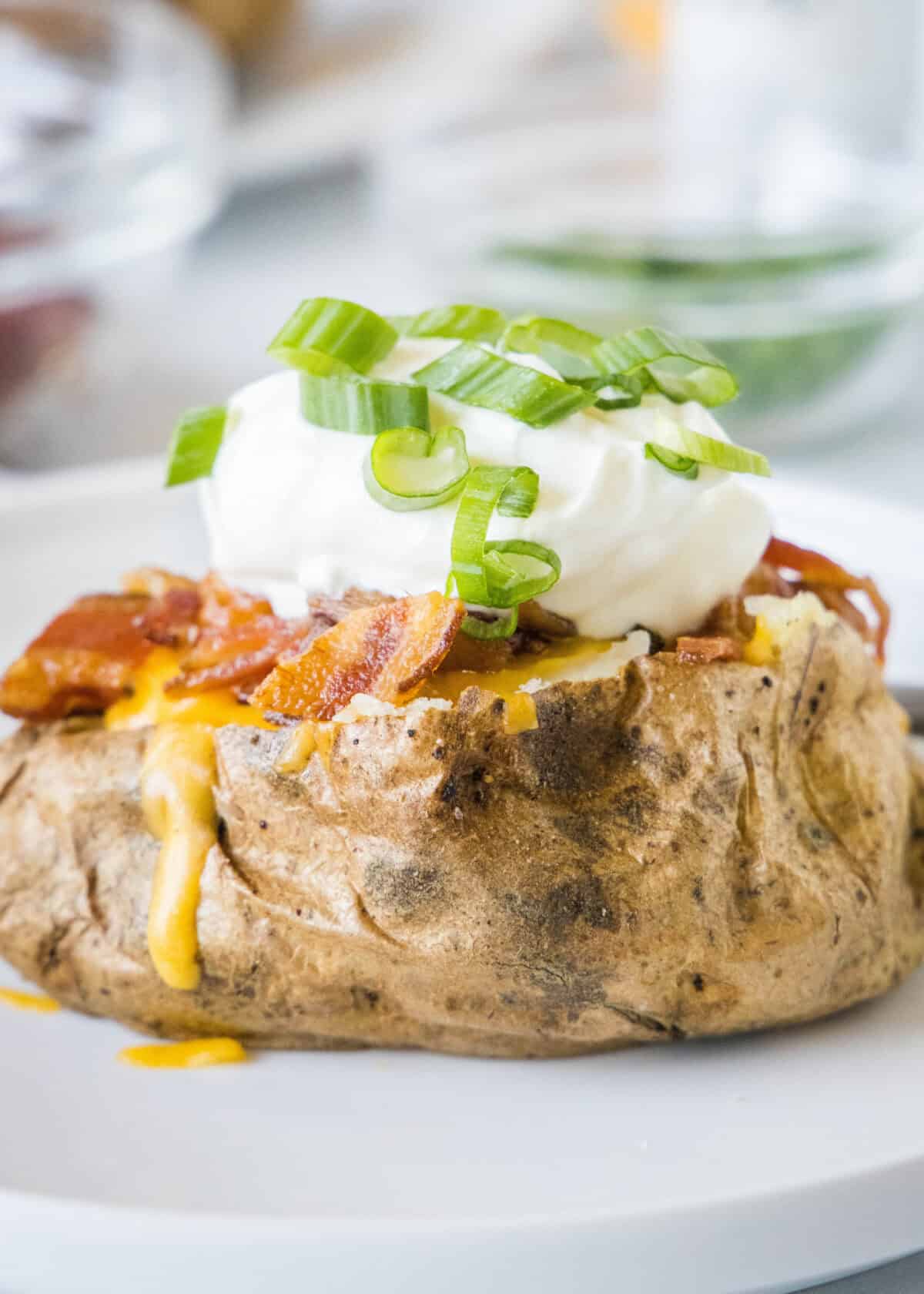 loaded baked potato on a white plate
