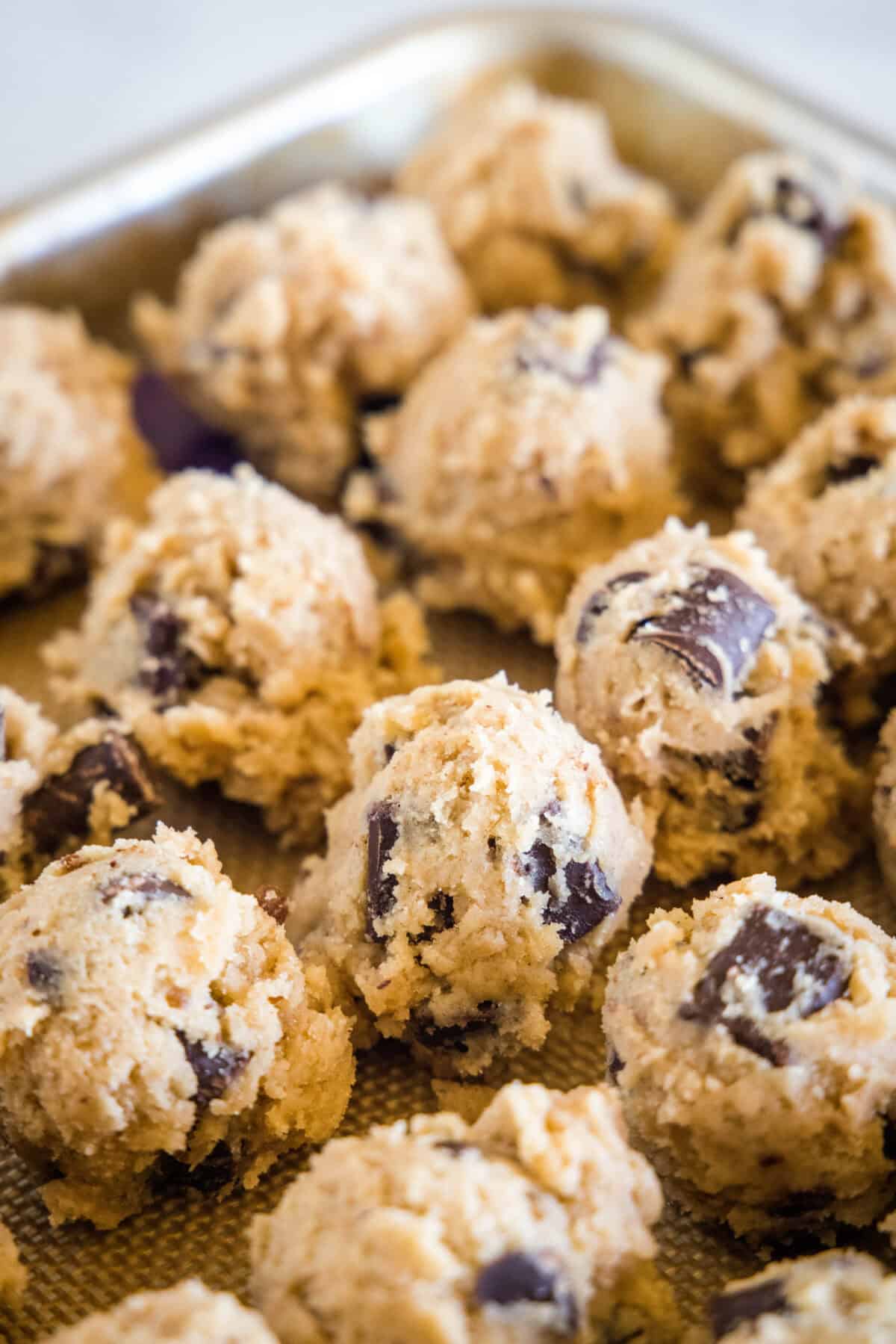 cookie dough balls on baking sheet