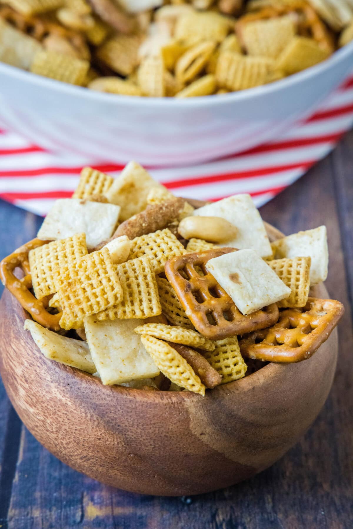 taco snack mix in a wood bowl with a serving bowl in the background