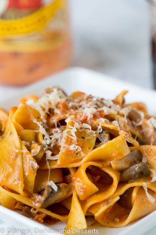 pasta with a mushroom tomato sauce topped with parmesan cheese
