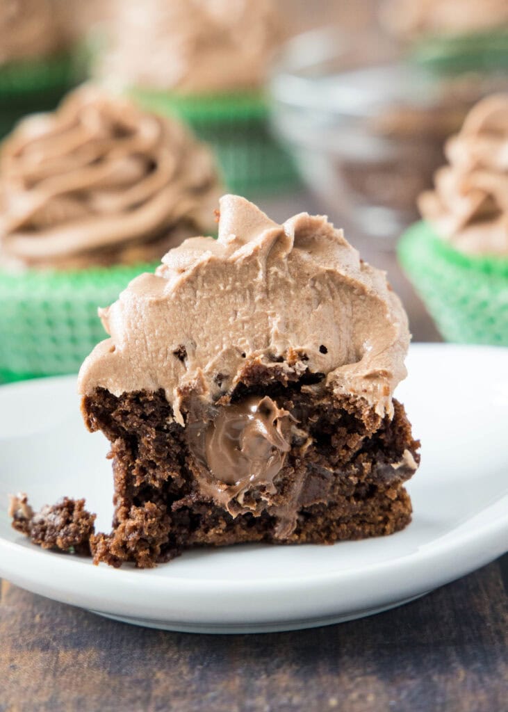 close of chocolate cupcakes filled with nutella on a white plate