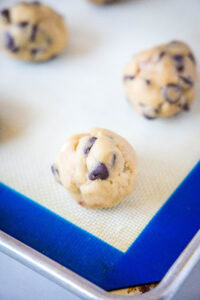 rolled balls of cookie dough on a baking sheet