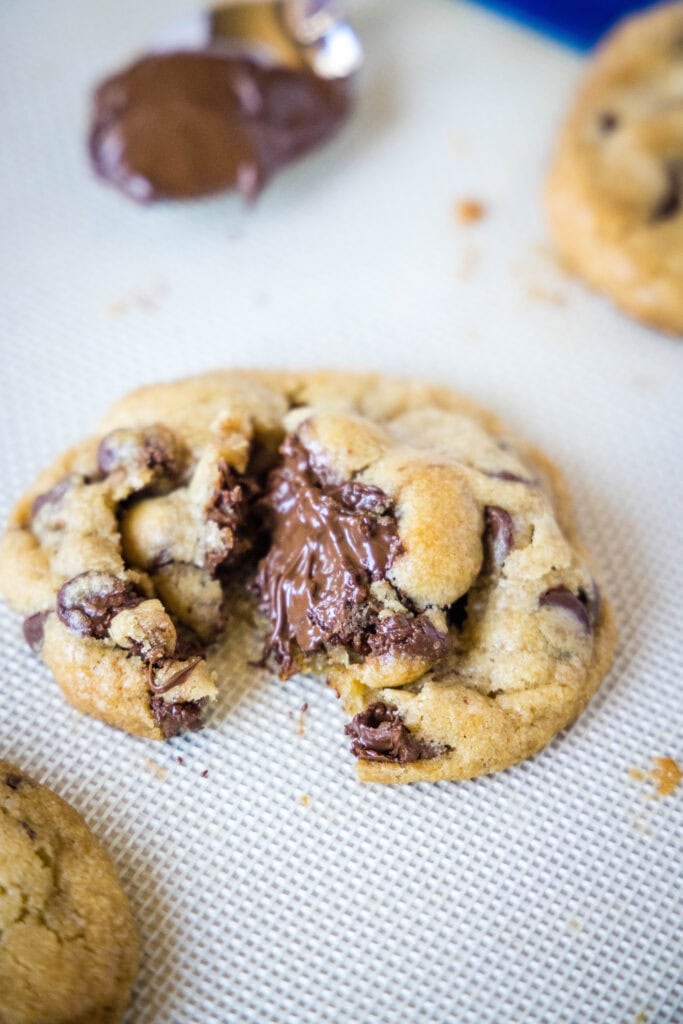 nutella stuffed cookie broken open on baking sheet