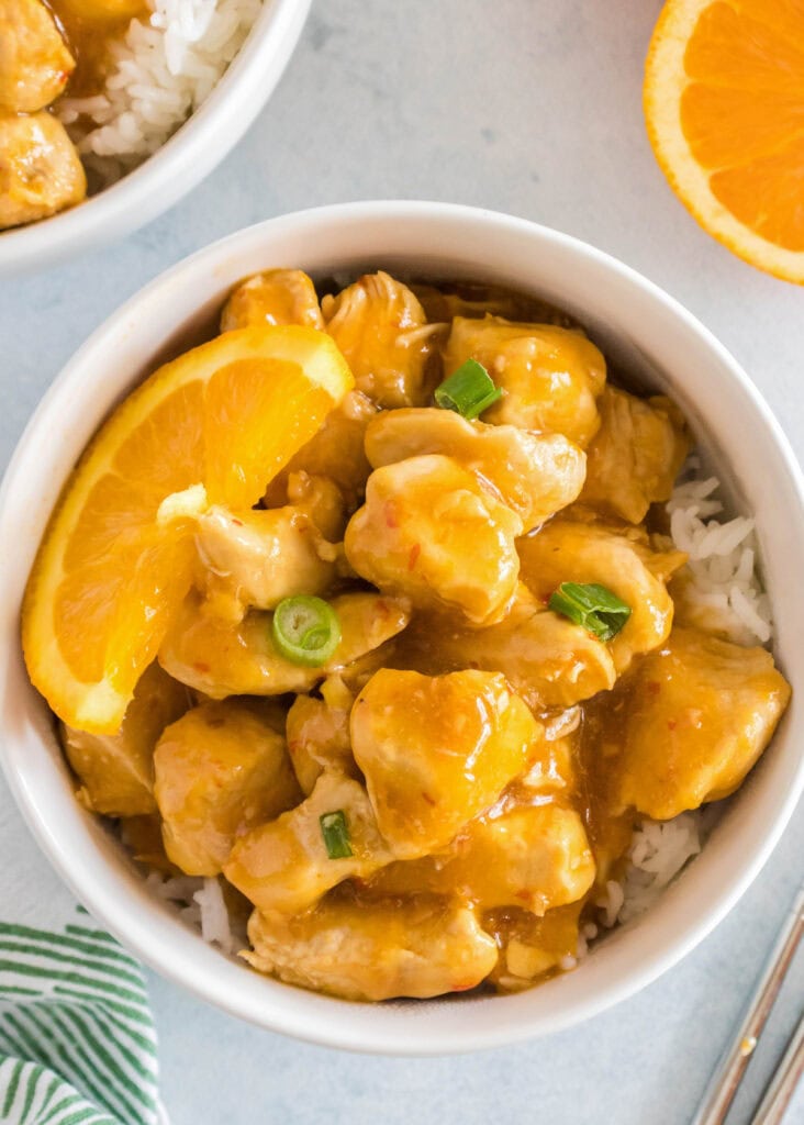 looking down on a bowl of orange chicken and rice