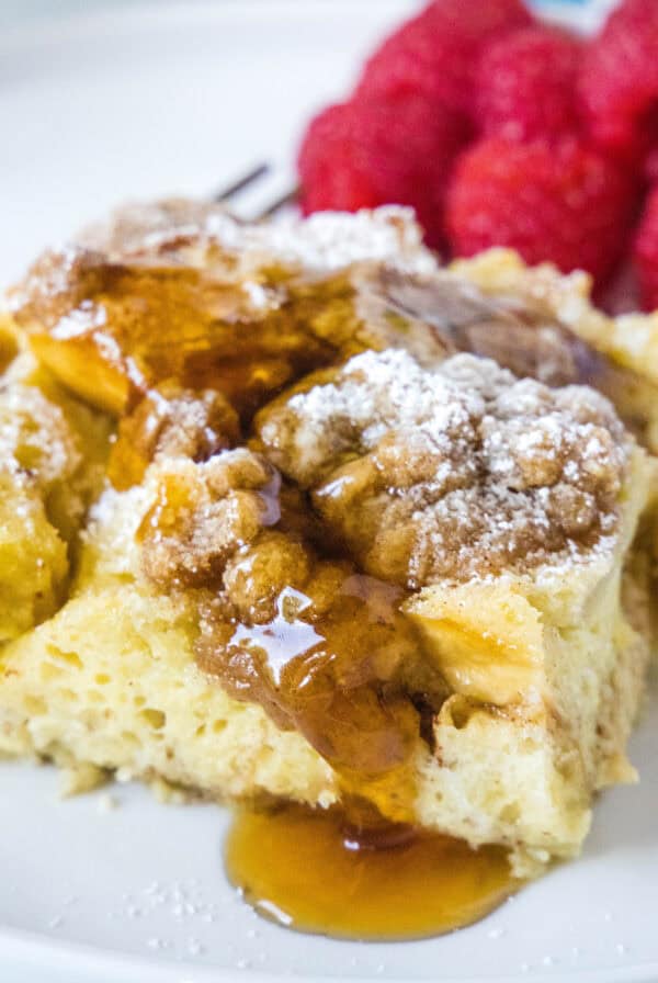cropped close up overnight french toast casserole topped with syrup