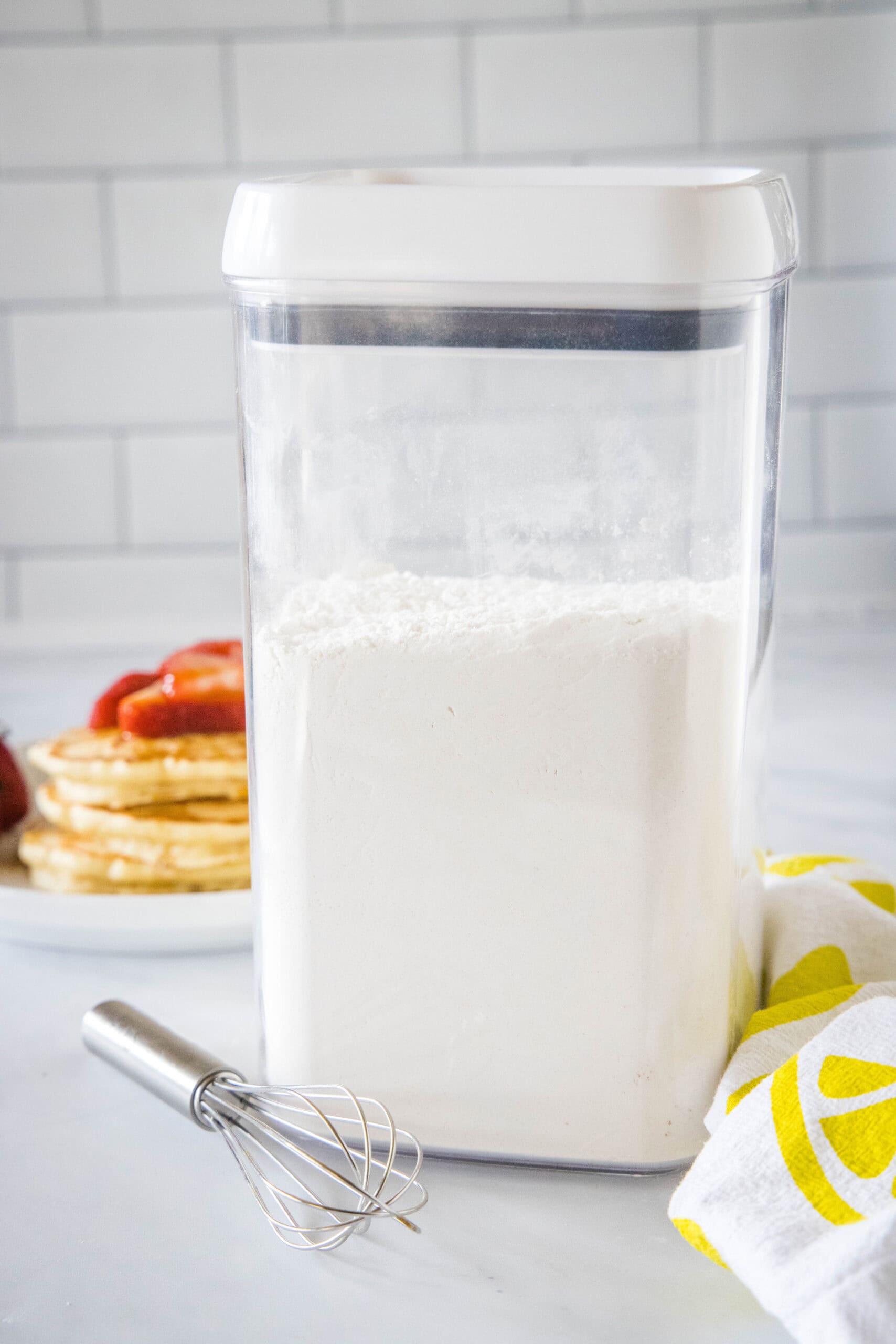 Homemade pancake mix in an airtight container on a countertop.