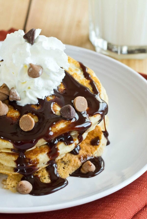 Peanut Butter Chocolate Chip Pancakes - Light and fluffy buttermilk pancakes topped with peanut butter, chocolate sauce, and whipped cream! It is like dessert for breakfast!