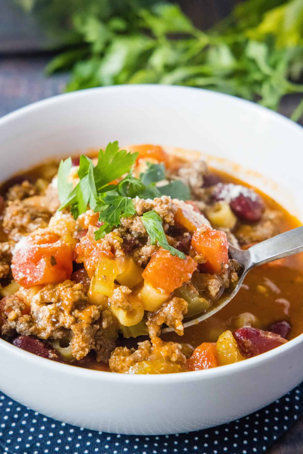 spooning pasta fagioli soup out of a bowl