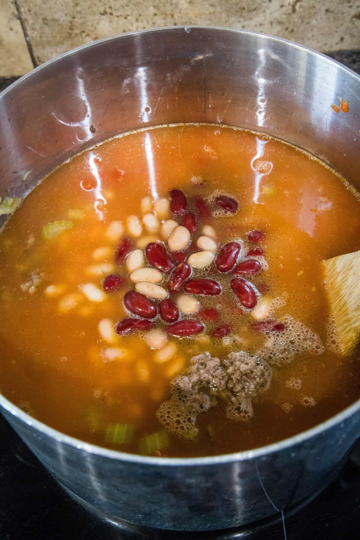 adding all the soup ingredients to a pot