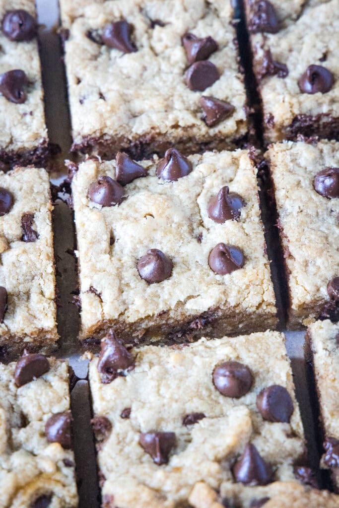 sliced peanut butter chocolate chip bars on a cutting board
