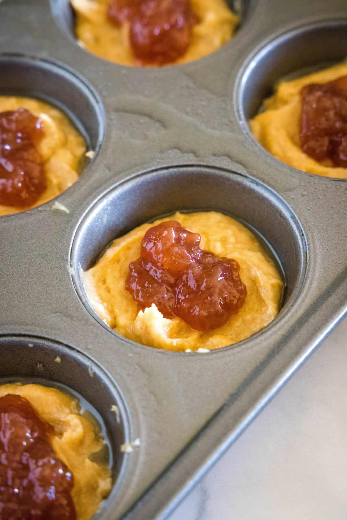 jelly in the middle of peanut butter muffins in muffin tin