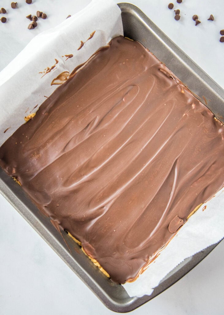 protein bars in pan with chocolate on top