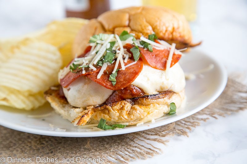 pepperoni pizza burger on a plate with potato chips